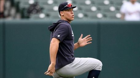 The Yankees' Aaron Judge warms up before a