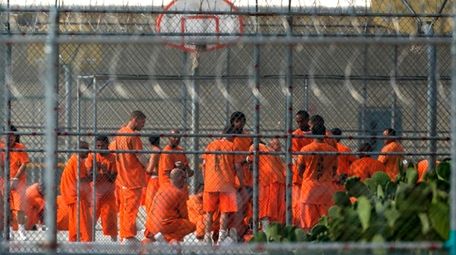 Prison inmates stand in the yard at Arizona