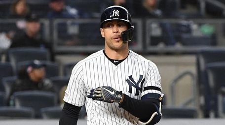The Yankees' Giancarlo Stanton reacts after he draws