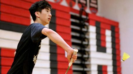 Commack's Andrew Wang returns the back hand volley