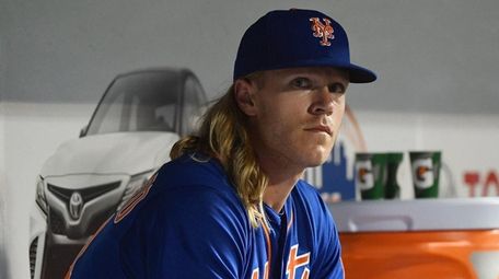 Mets starting pitcher Noah Syndergaard looks on from