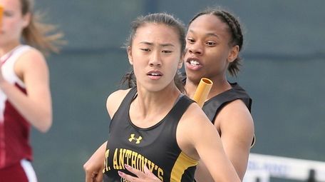 St. Anthony's runner Ashia Smith hands off to