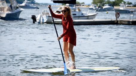 Christina Losquadro, 29, of Long Beach paddles back