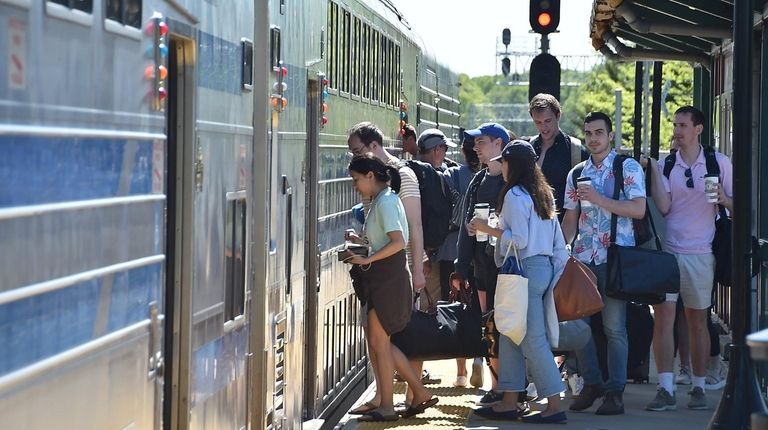 Passengers board a westbound Long Island Rail Road