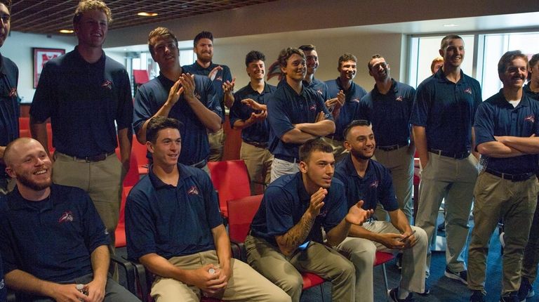 Stony Brook baseball players and coaches watch at