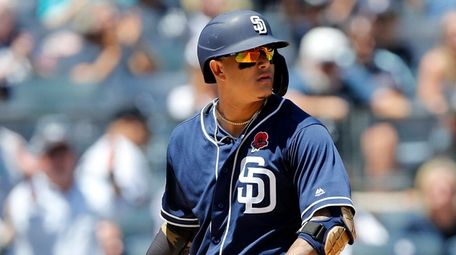 Manny Machado of the Padres strikes out to