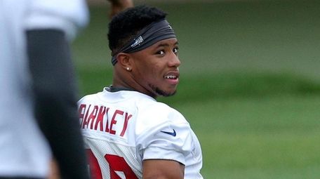 Giants running back Saquon Barkley stretches during OTAs