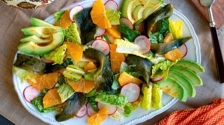 Bright orange slices, roasted chiles, romaine, radishes and
