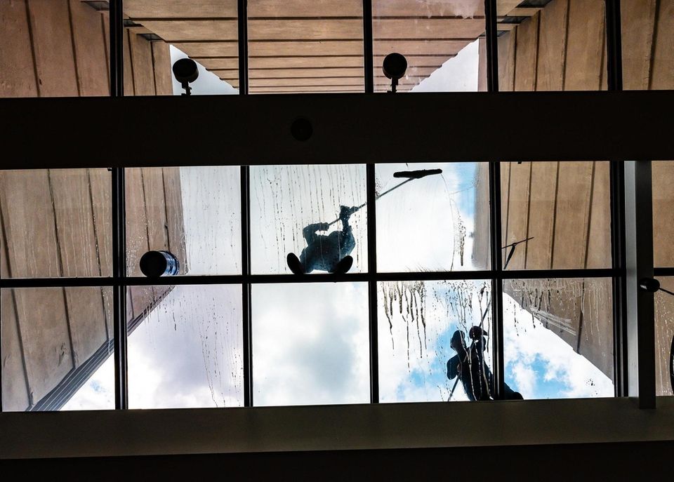 Workers clean the ceiling glass at the Marriott