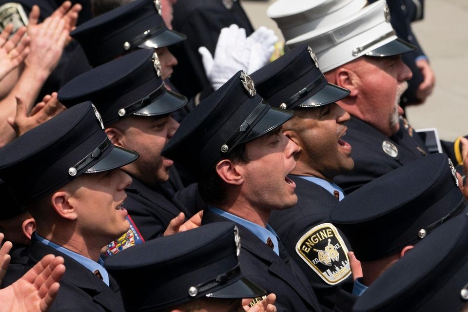 Members of the FDNY cheers as Lieutenant Patrick