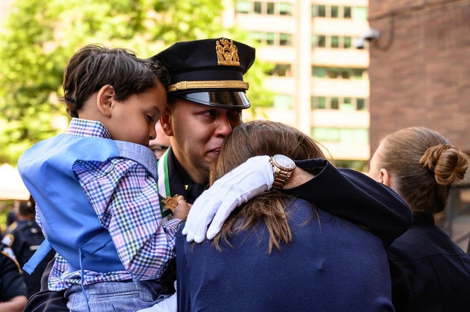 Sgt. Arvid Flores comforts Lisa Tuozzolo after he