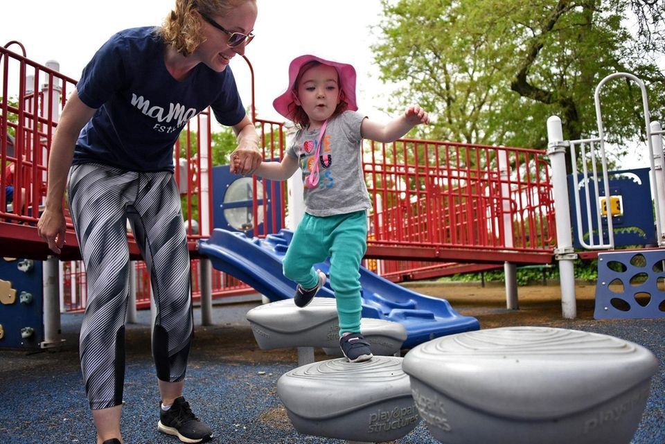 Nina Chalson, 23 months, of Sea Cliff, climbs