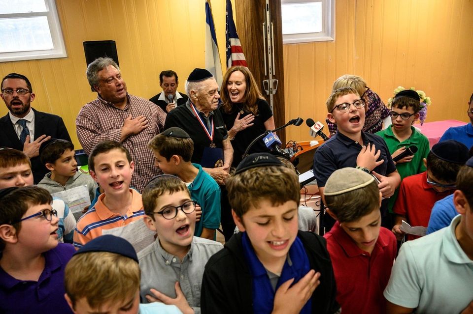 Marvin Jacobs, (center) a 97 year-old Holocaust survivor
