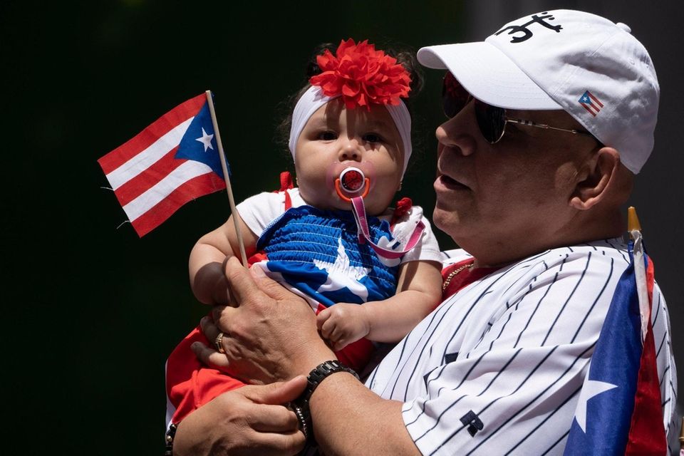 Hector Avila holds his granddaughter Rylee Rosado during