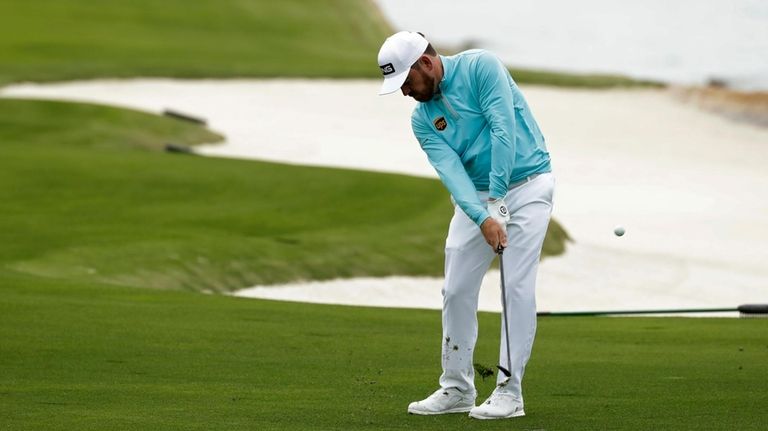 Louis Oosthuizen, of South Africa, hits a chip