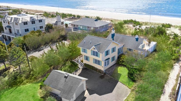 This 5-bedroom, 3 1/2-bathroom Quogue property sits on