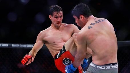 Rory MacDonald, left, kicks Neiman Gracie during the