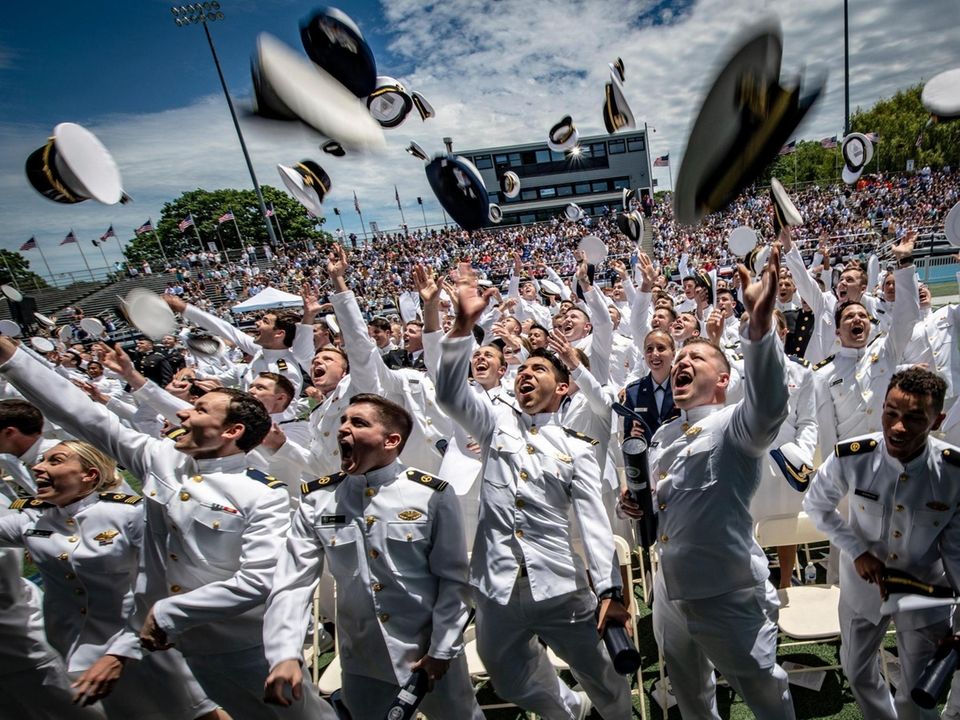 The class of 2019 sing cheer tossing their