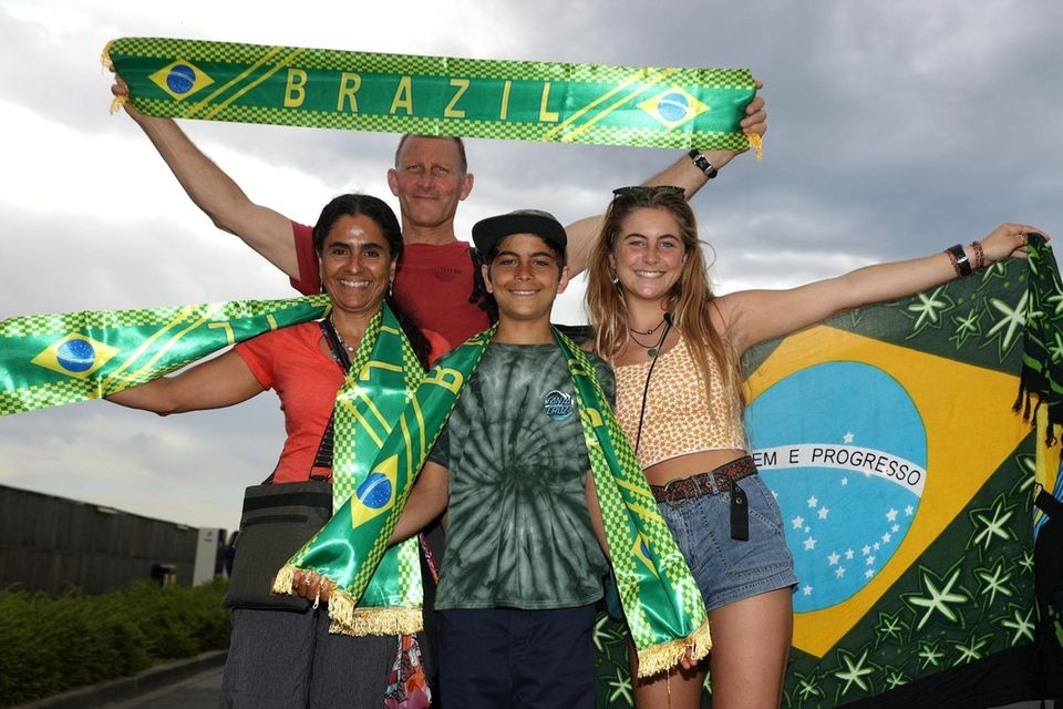 Fans pose for a photograph outside the stadium