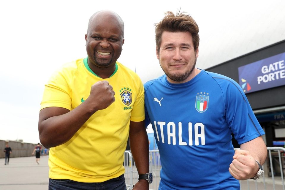 Fans pose for a photograph outside the stadium
