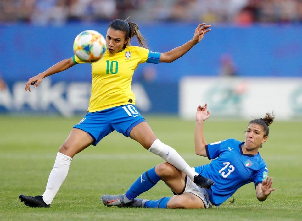 Brazil's Marta, left, duels for the ball with
