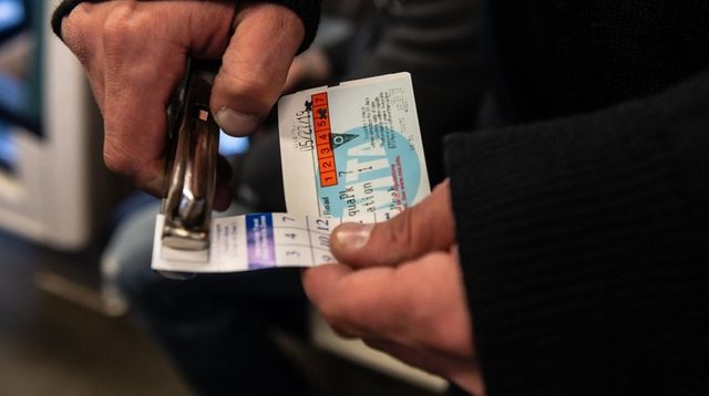 LIRR conductor Anthony Massa punches tickets on an... LIRR conductor Anthony Massa punches tickets on an