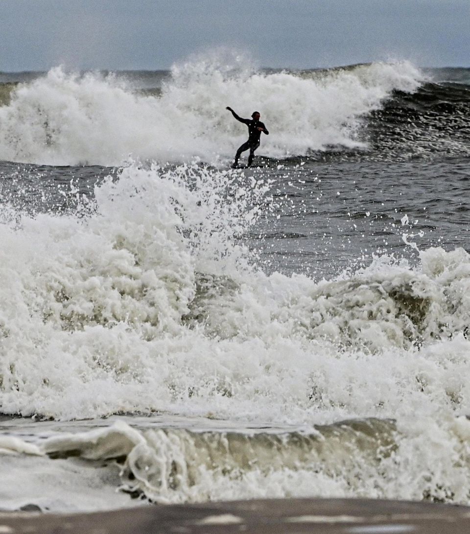 A surfer takes advantage of the high surf