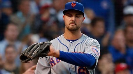 The Mets' Walker Lockett, right, reacts as the