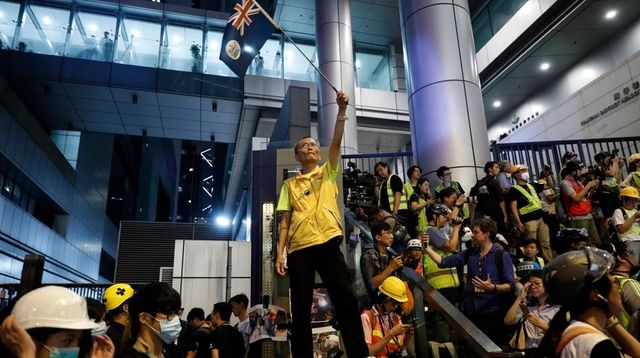 A protester waves a Hong Kong flag outside... A protester waves a Hong Kong flag outside