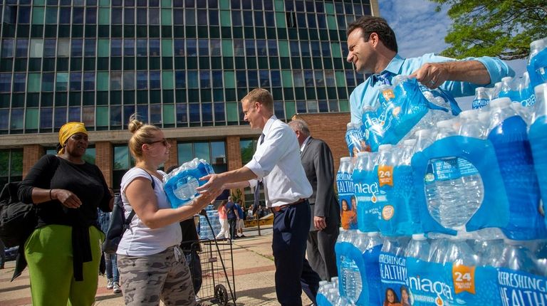 City officials hand out cases of bottled water