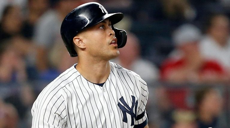 Giancarlo Stanton of the Yankees follows through on