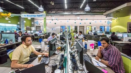 Broadridge Financial Solutions employees work at their investor