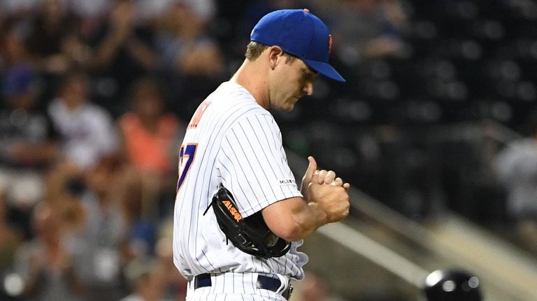 Mets relief pitcher Seth Lugo reacts on the