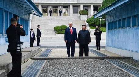 President Donald Trump stands with North Korea's leader