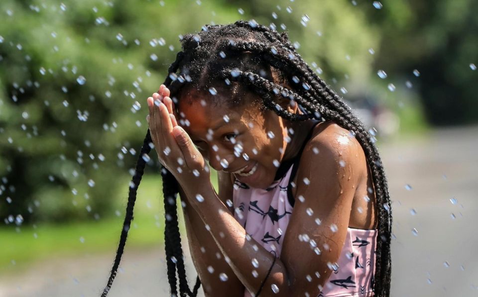 Trying to escape the heat, eight-year-old Briasia Kite,