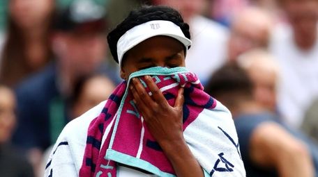 Venus Williams reacts as she sits down between