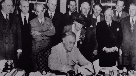 President Franklin D. Roosevelt signs Public Law 346,