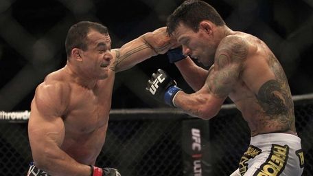 Gleison Tibau, left, punches Rafael Dos Anjos, from