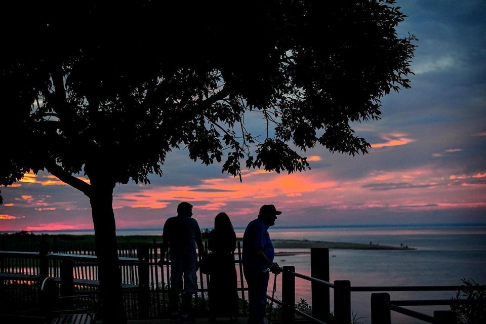 People gather to watch the sun set from