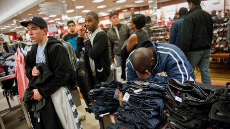 Shoppers wait in line to purchase their items