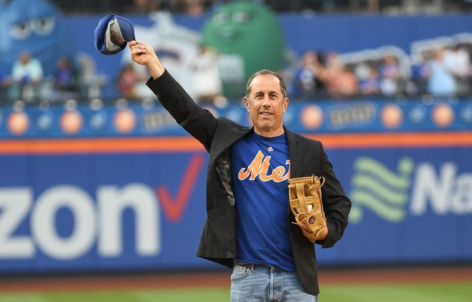 Comedian Jerry Seinfeld waves to fans before throwing