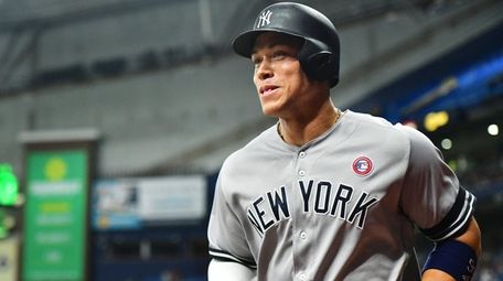 Aaron Judge smiles after scoring during the tenth