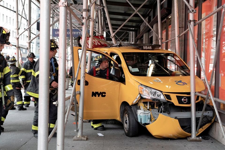 Emergency personnel respond after a taxi crashed into
