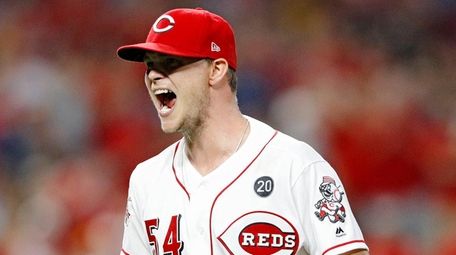 Reds pitcher Sonny Gray reacts after getting the