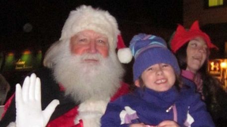 Isabella Capizzi, 6, of Babylon sits on Santa