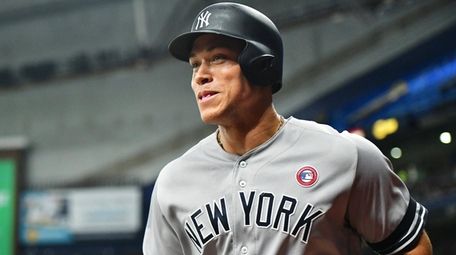 The Yankees' Aaron Judge smiles after scoring during