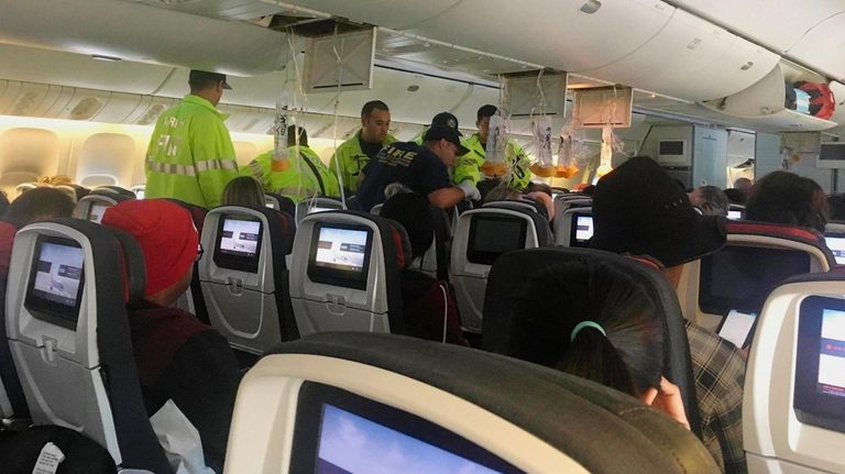 Responders treat a passenger on an Air Canada