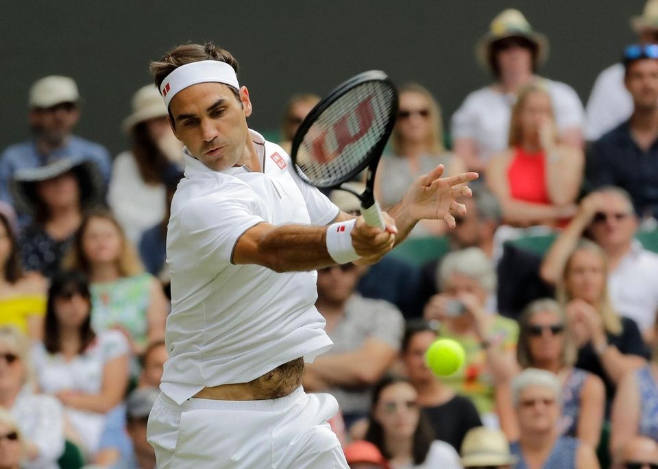 Switzerland's Roger Federer returns the ball to Spain's