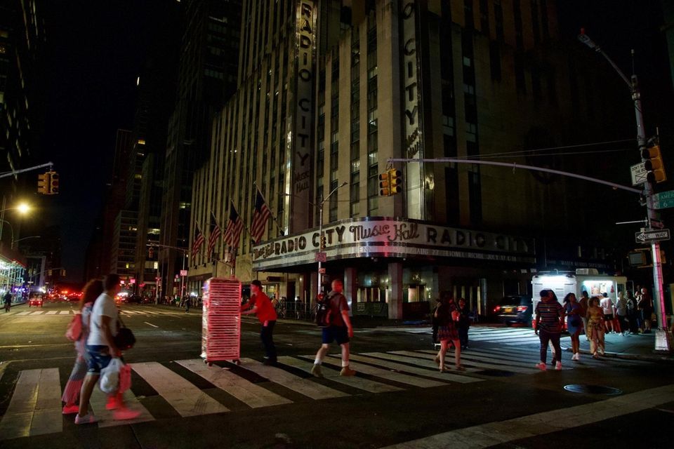 Pedestrians walk near Radio City Music Hall. A