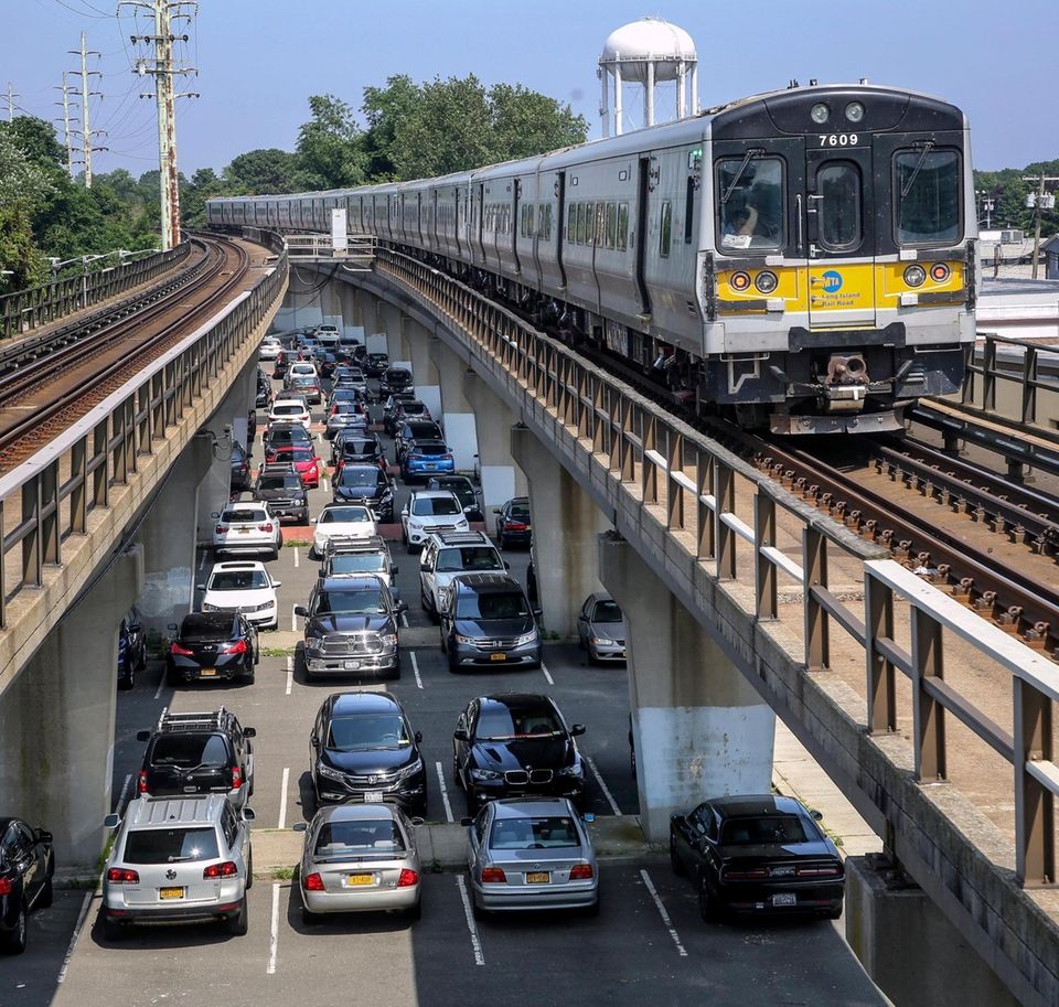 Cars belonging to commuters are parked below the